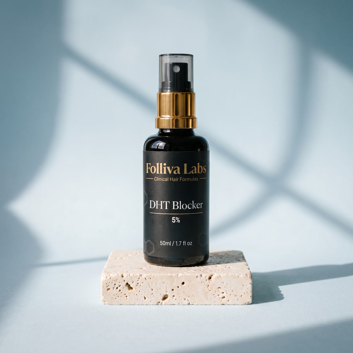 Folliva DHT Blocker 5% spray bottle on a stone plinth in window light